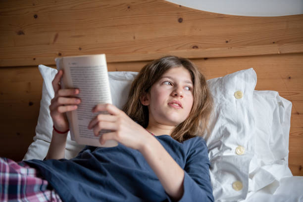 istock Little girl reading a book 946784496
