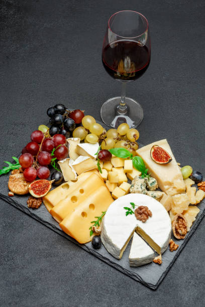 istock various types of cheese and wine on stone serving board 946788620