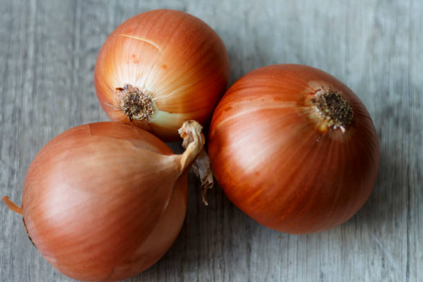 istock tree fresh, full of vitamins onions lay on the table 946790908