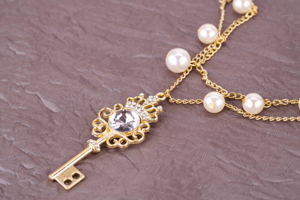 istock Stylish necklace with pearls and key 946791840