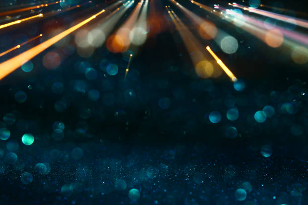 istock glitter vintage lights background. black, blue and gold. de focused. 946792148