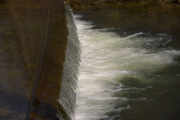 istock Weir on the river, the sun shines. 946792828