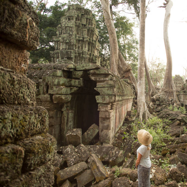 istock Woman admires buddhist temple at Angkor Wat 946803750