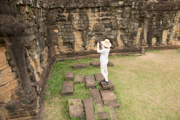 istock Woman explores buddhist temple at Angkor Wat 946803824