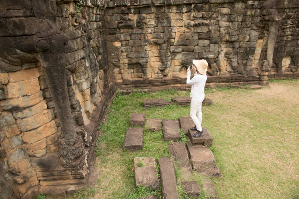 istock Woman explores buddhist temple at Angkor Wat 946803886