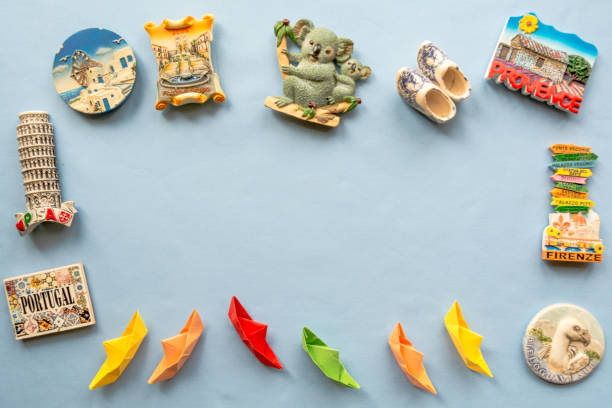 istock various souvenir magnets and paper ships arranged on the blue background 946804450