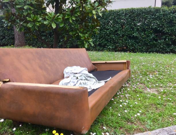 istock An old ruined sofa in the garden (Pesaro, Italy) 946806890