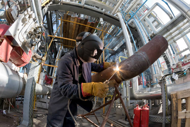 istock Welding works on metal  heat exchanger using manual arc welding 946808034