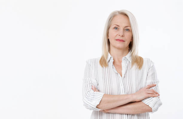 istock Friendly smiling middle-aged business woman isolated on white background 946810730