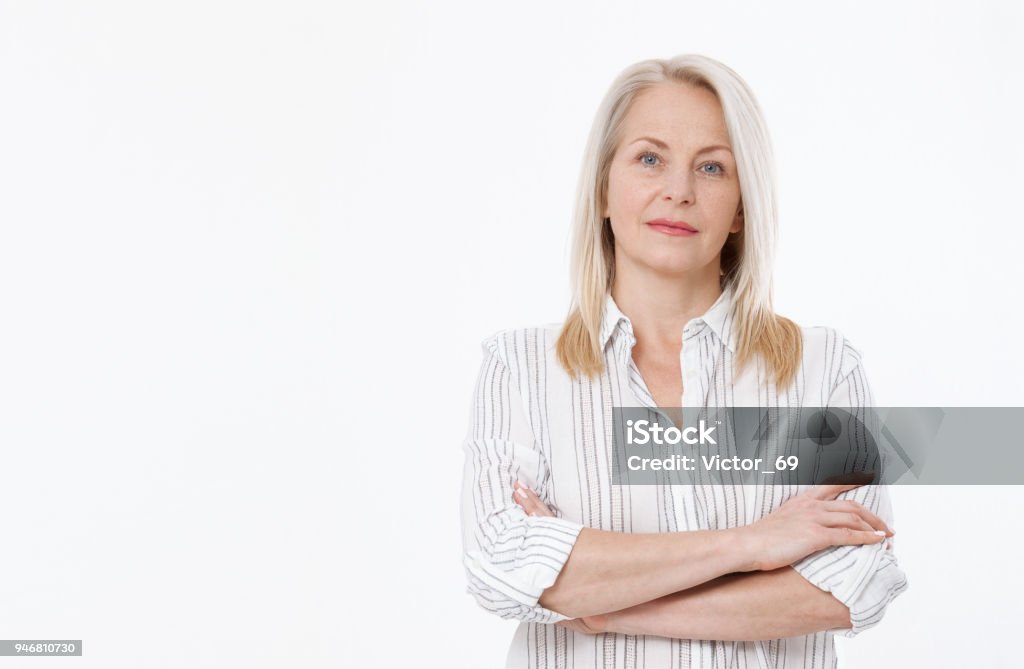 Friendly smiling middle-aged business woman isolated on white background Friendly smiling middle-aged woman isolated on white background Serious Stock Photo