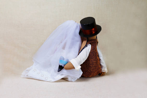 istock Easter rabbits, bunny toys in shape wedding. Textile bride and groom, behind 946812088