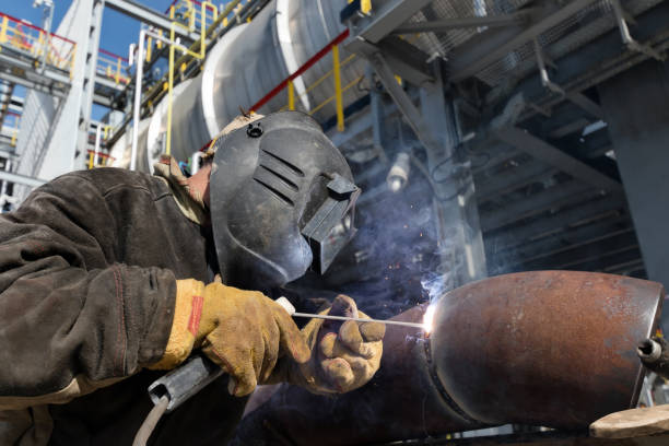 istock Welding works on metal  heat exchanger using manual arc welding 946815450