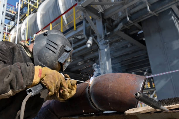 istock Welding works on metal  heat exchanger using manual arc welding 946815692