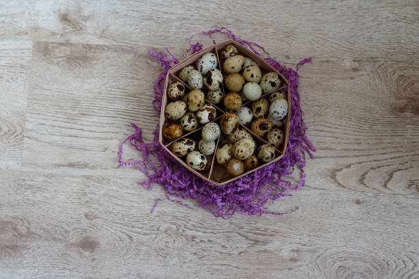 a basket with quail eggs stands on a violet decor