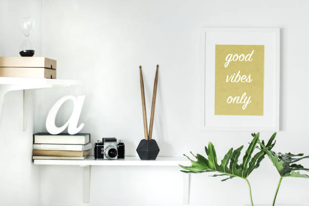 istock The modern interior with shelfs, camera, books, leafs and mock up frame. 946820000