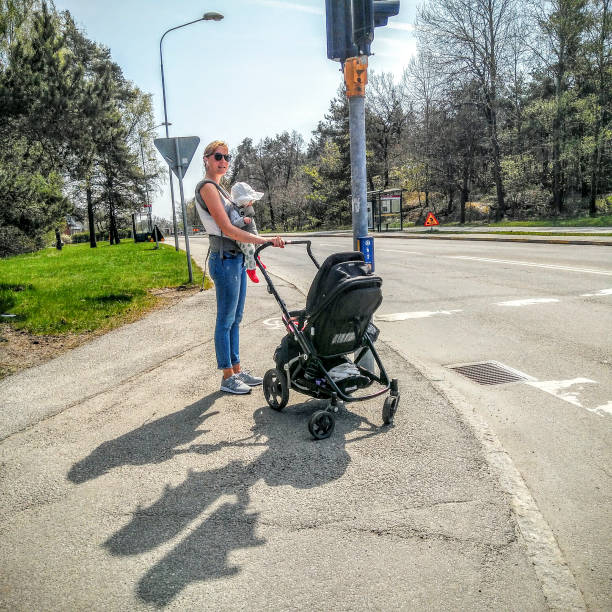 STOCKHOLM, SWEDEN Young mother at crosswalk in Fruangen suburb.