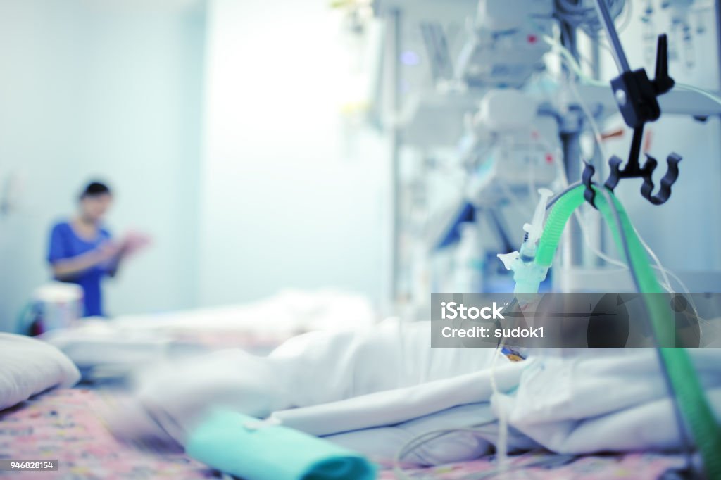 Heavy breathing baby with the help of the apparatus and oxygen in a hospital bed in modern NICU Heavy breathing baby with the help of the apparatus and oxygen in a hospital bed in modern NICU. Intensive Care Unit Stock Photo