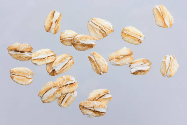 oat flakes isolated on white background. close up. - oat imagens e fotografias de stock