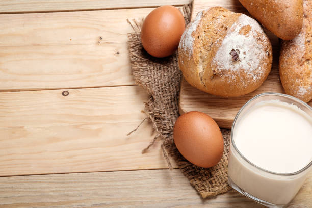 istock milk and bread on wooden background 946832298