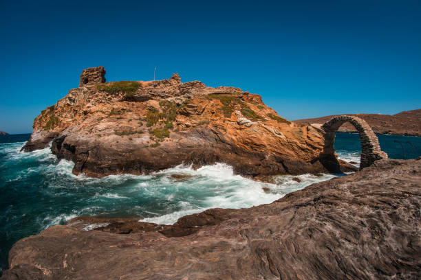 Ancient bridge to small island near the town of Andros, Andros, Greece Scenic view to ancient bridge to small island near the town of Andros, Andros, Greece andros island stock pictures, royalty-free photos & images