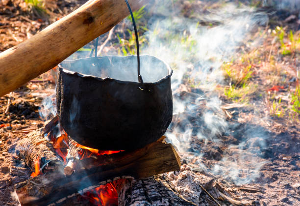 istock cauldron in steam and smoke on open fire 946835470