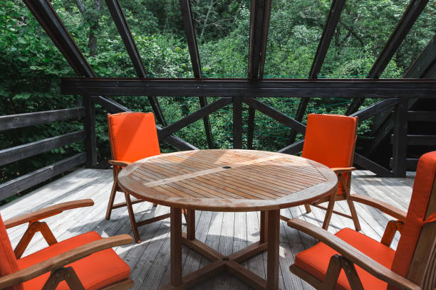 istock Summer country terrace with a table and orange chairs. Interior details 946835540