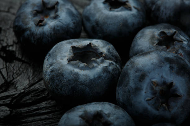 istock Blueberries background. Blueberry on black old wood 946835658