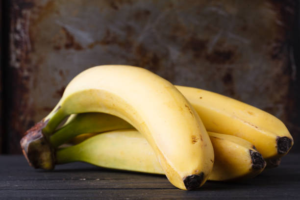 istock Close up of few bananas on rustic table 946835720