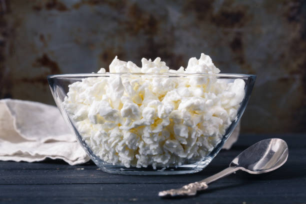 istock Natural fat cottage cheese homemade in dish on rustic table 946835762