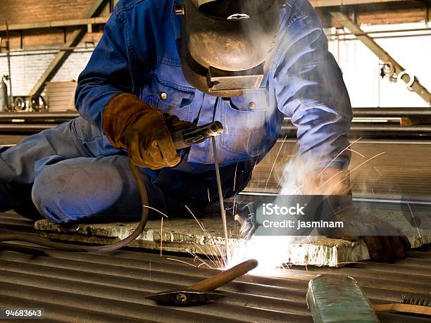 A Man At Work Welding A Project Stock Photo - Download Image Now - Blue-collar Worker, Color Image, Construction Industry