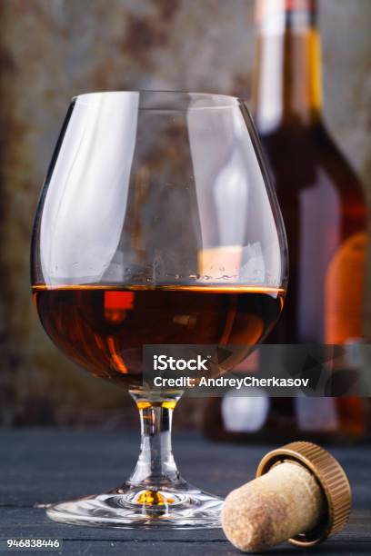 Glass Of Cognac On Rustic Ferruginous Background Stock Photo - Download Image Now - Addiction, Alcohol - Drink, Brandy