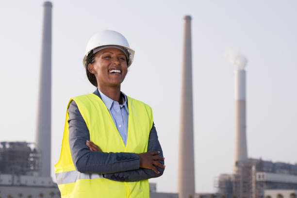 istock Woman worker against electric power station. 946839026
