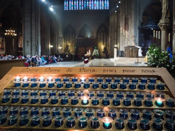 Votive candles inside the Notre Dame cathedral in Paris, France.