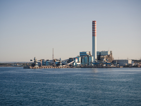 Civitavecchia, Italy - August 27, 2017: The ENEL Tower of Torrevaldaliga Nord is a coal-fired power plant with a total capacity of 1980 MW.