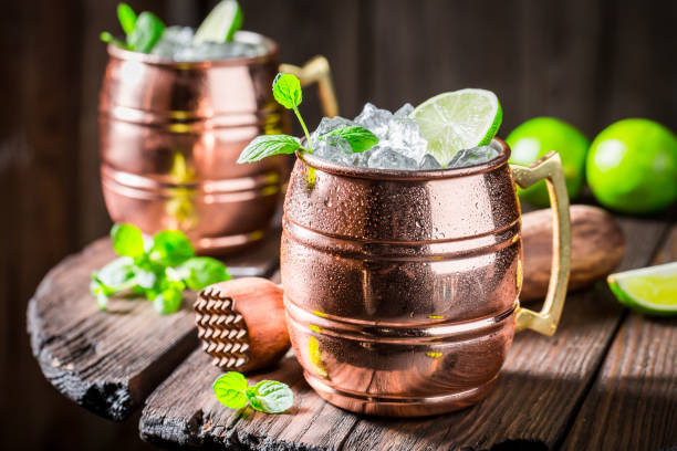 istock Refreshing Mojito with lime and mint on wooden table 946839690