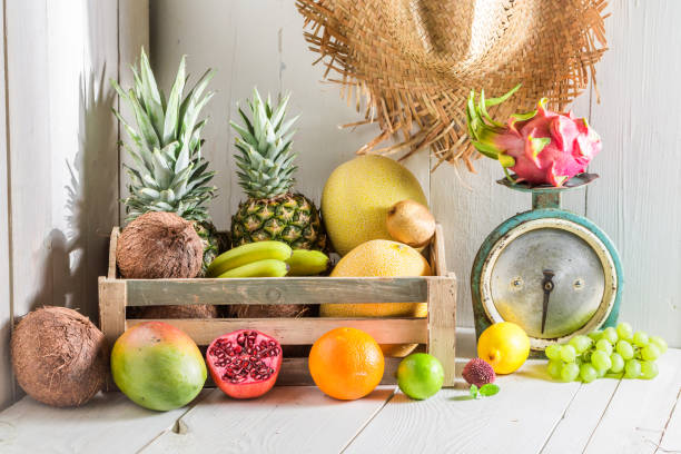istock Mix of fresh tropical fruits on a white table 946840002