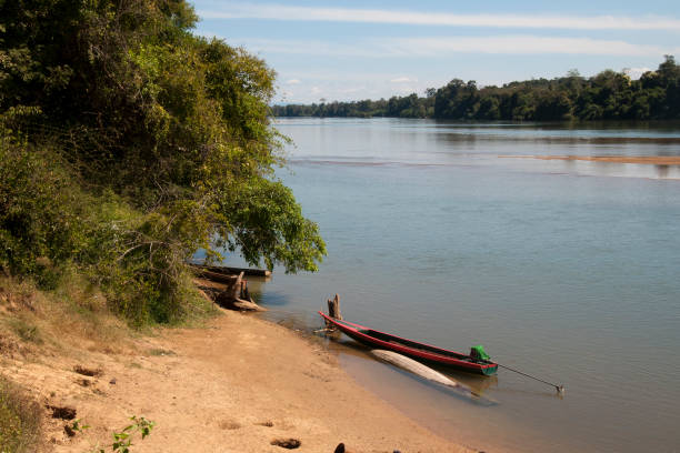 istock View of river with beach and long boat in foreground 946842558