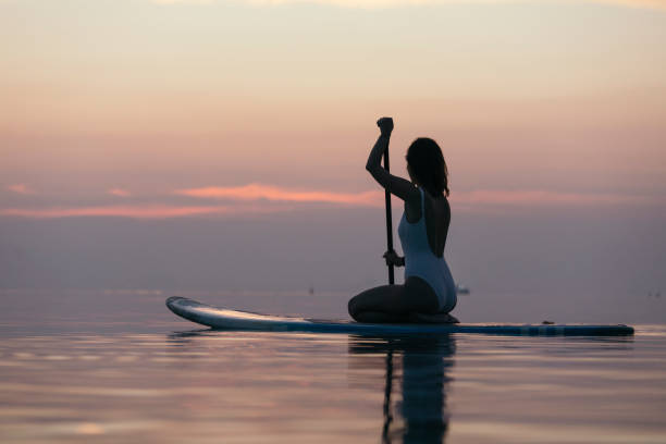istock Beautiful girl on paddle board 946845218