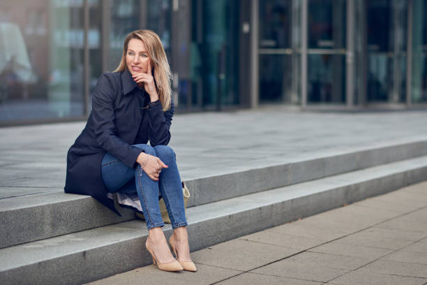 istock Attractive stylish woman sitting on urban steps 946846276