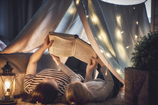 istock Mom and child reading a book 946853654
