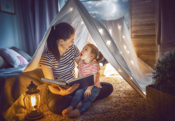 istock Mom and child reading a book 946853676