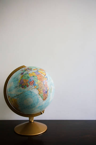 istock Globe model on dark wooden desk 946856934