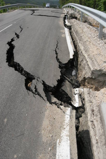 istock Road collapses with huge cracks. International road collapsed down after bad construction. Damaged Highway Road. Asphalt road collapsed and fallen. Erosion 946857420