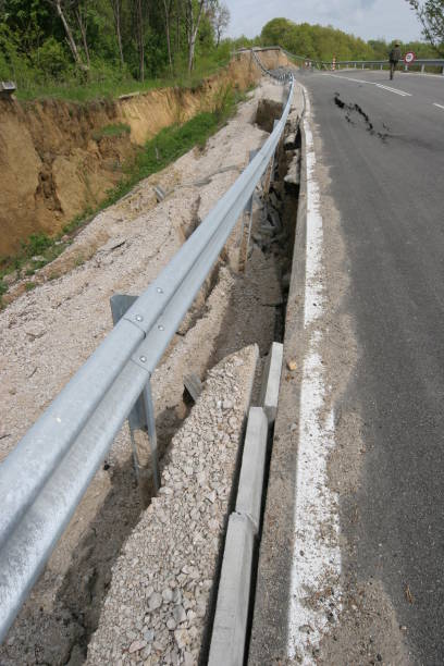 istock Road collapses with huge cracks. International road collapsed down after bad construction. Damaged Highway Road. Asphalt road collapsed and fallen. Erosion 946857626