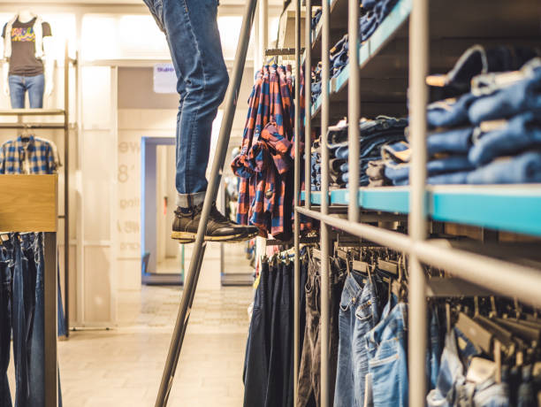 istock man picking jeans in the clothes store on the ladder 946858244