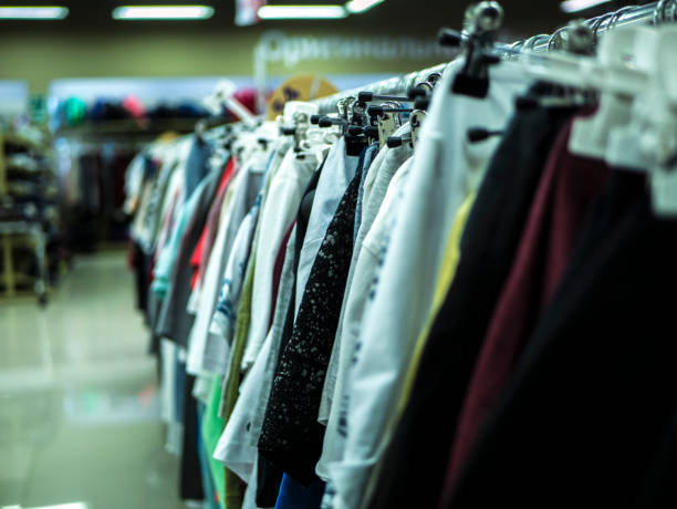 istock close up clothes hanging row in the store 946858304