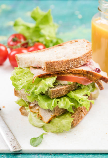 istock Tower healthy sandwich with ham and salad 946860834