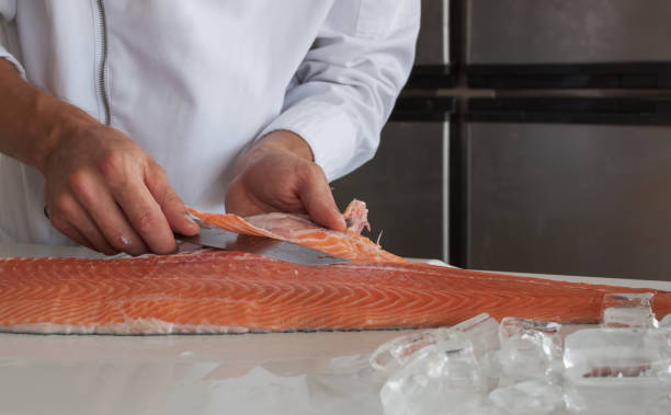 istock The chef cuts and debone salmon on the table. 946861594