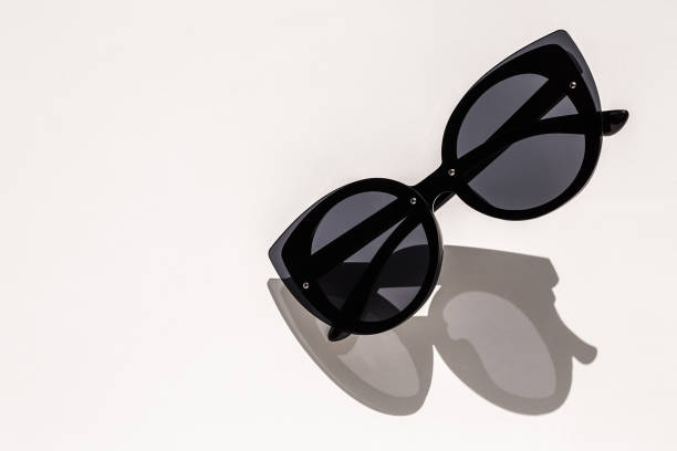 istock Black female sunglasses on white in the sunlight 946862908