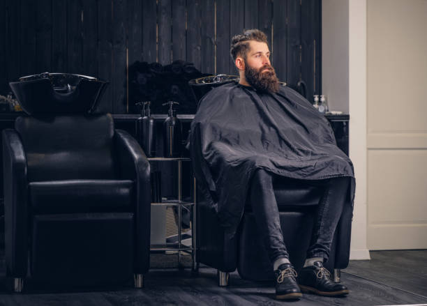istock Handsome bearded man in the barbershop. 946865076